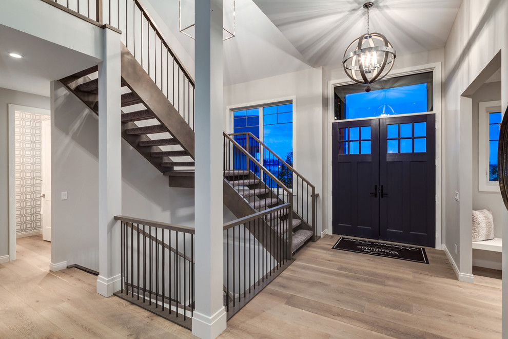 Front door - transitional light wood floor front door idea in Calgary with beige walls and a blue front door