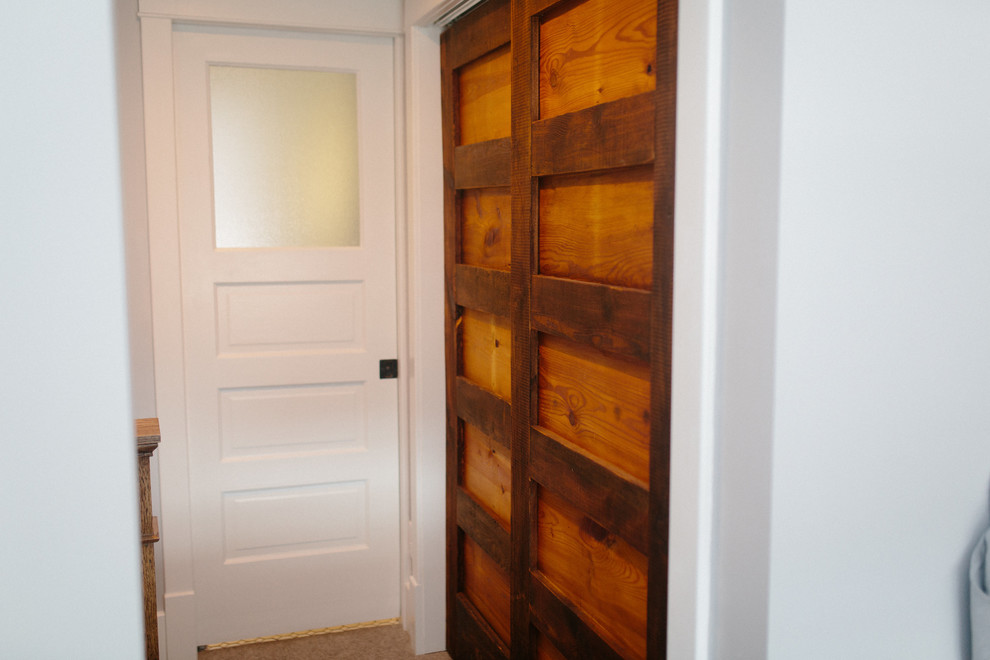 Hallway - mid-sized rustic carpeted and beige floor hallway idea in Omaha with white walls
