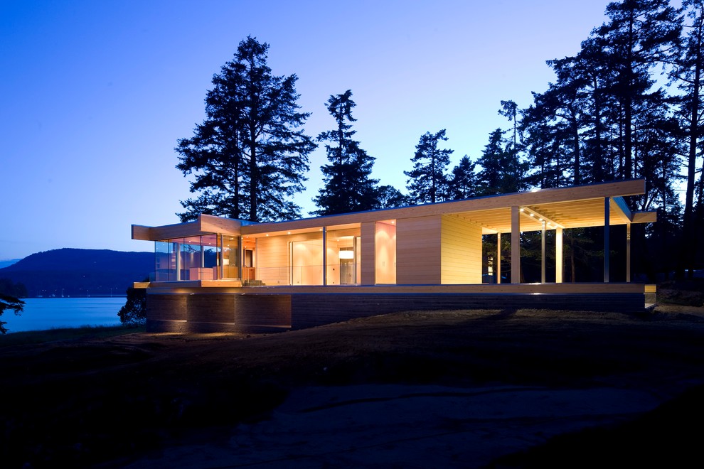 Design ideas for a large modern two-storey glass multi-coloured house exterior in Vancouver with a flat roof.