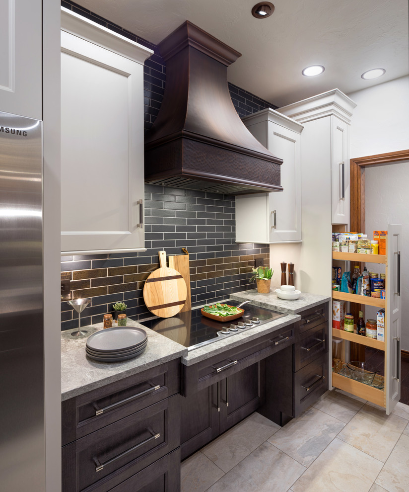Design ideas for a mid-sized arts and crafts galley open plan kitchen in Oklahoma City with a farmhouse sink, shaker cabinets, quartz benchtops, metallic splashback, porcelain splashback, stainless steel appliances, porcelain floors, a peninsula, grey floor and grey benchtop.