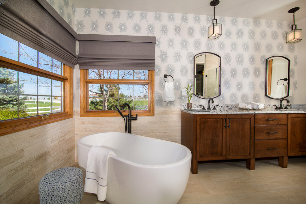 Inspiration for a mid-sized transitional master beige tile and porcelain tile porcelain tile and beige floor freestanding bathtub remodel in Denver with raised-panel cabinets, medium tone wood cabinets, multicolored walls, an undermount sink, granite countertops and a hinged shower door