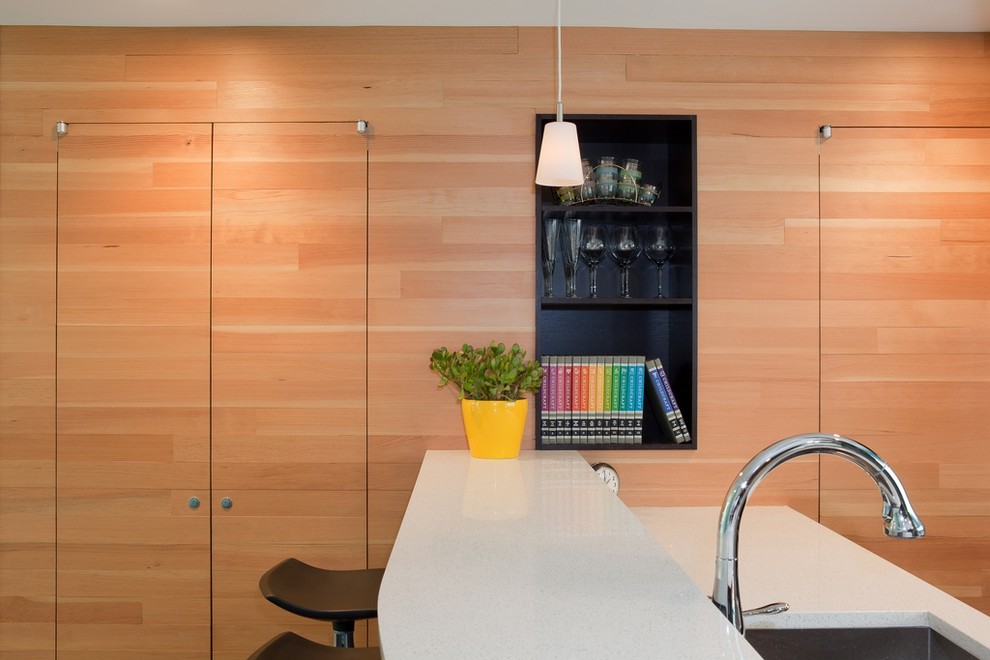 Midcentury kitchen in Seattle with flat-panel cabinets and light wood cabinets.
