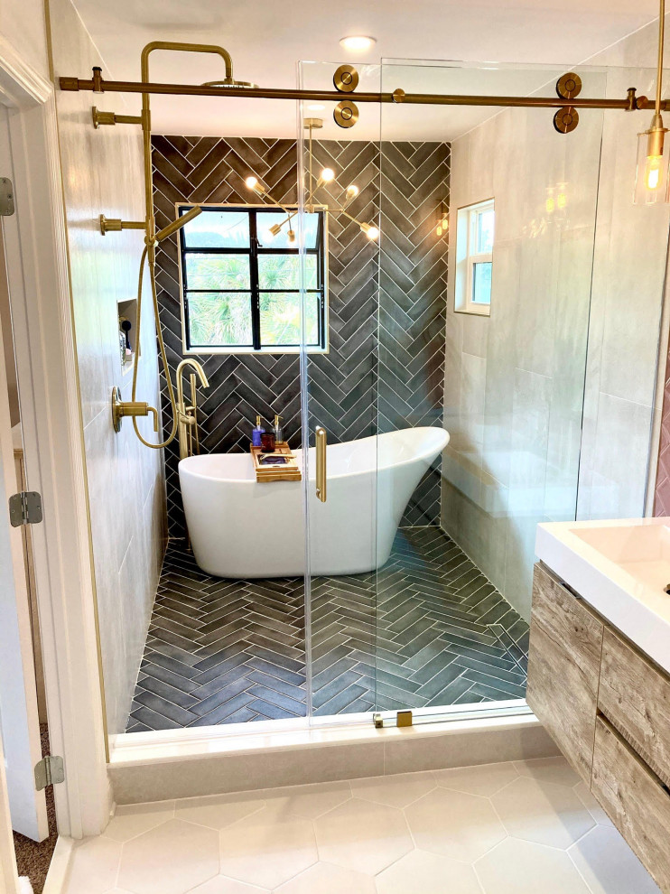 Design ideas for a large modern master wet room bathroom in Tampa with shaker cabinets, light wood cabinets, a freestanding tub, black tile, subway tile, grey walls, ceramic floors, a trough sink, white floor, a sliding shower screen, white benchtops, a single vanity and a floating vanity.