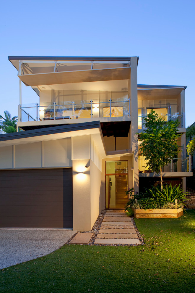Inspiration for a large contemporary three-storey concrete beige exterior in Brisbane with a shed roof.