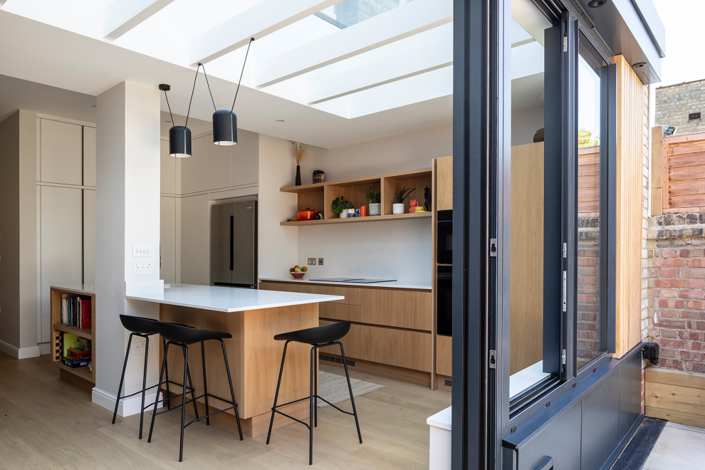 A light-filled rear extension with a striking glass roof and minimalist ...