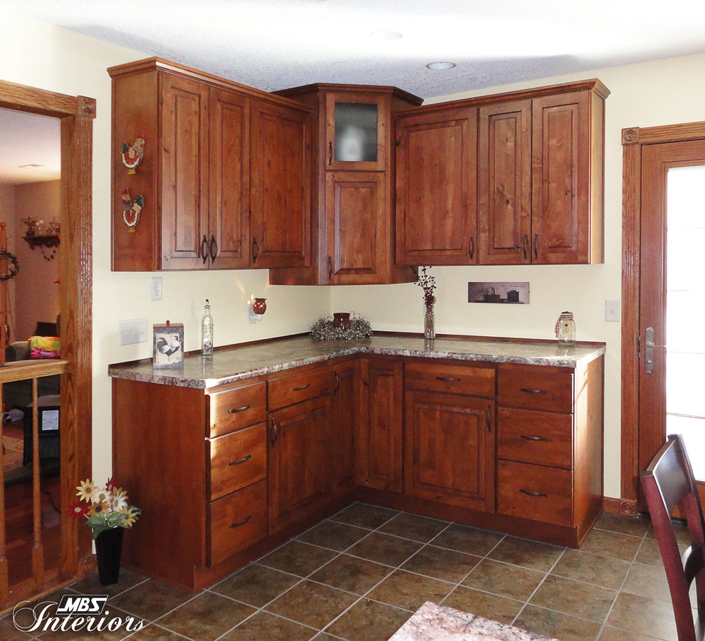 Home design - rustic home design idea with an undermount sink, medium tone wood cabinets, laminate countertops, gray backsplash, metal backsplash and stainless steel appliances