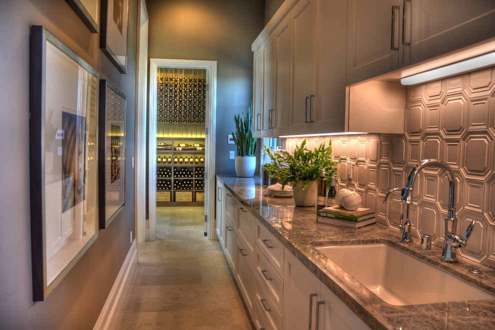 This is an example of a mid-sized traditional wine cellar in Orange County with terra-cotta floors and display racks.