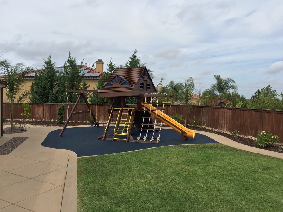 Photo of a traditional backyard garden in San Diego with with outdoor playset.