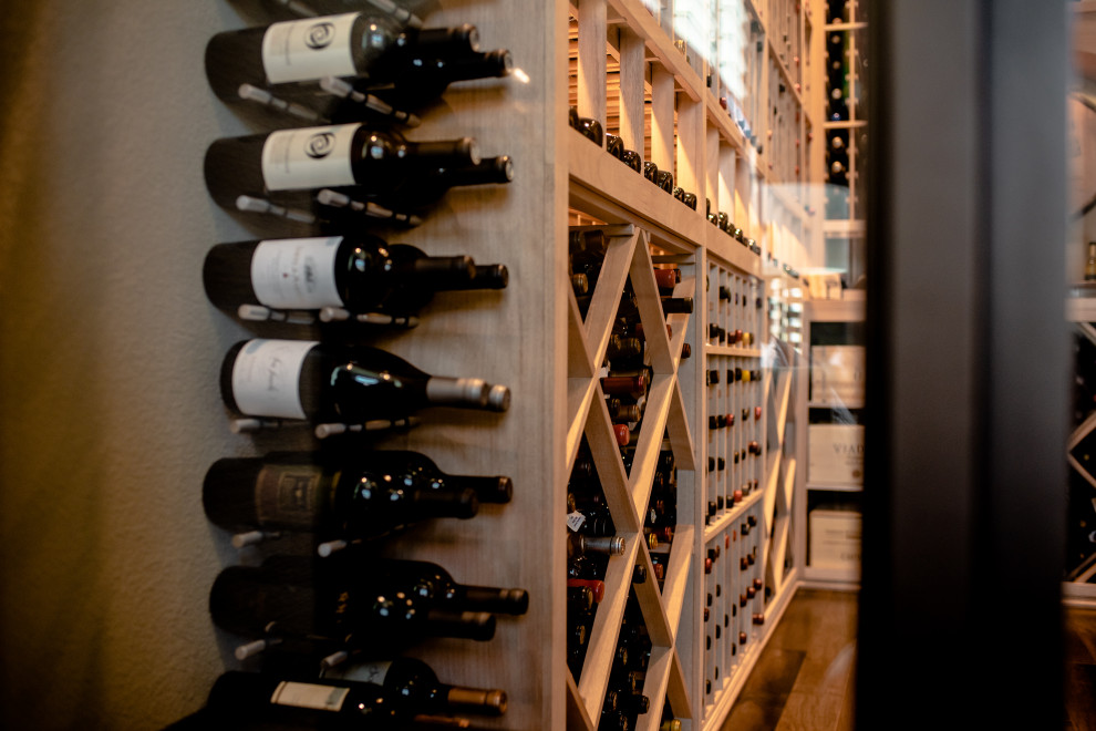 Inspiration for a mid-sized contemporary wine cellar in Dallas with storage racks and brown floor.