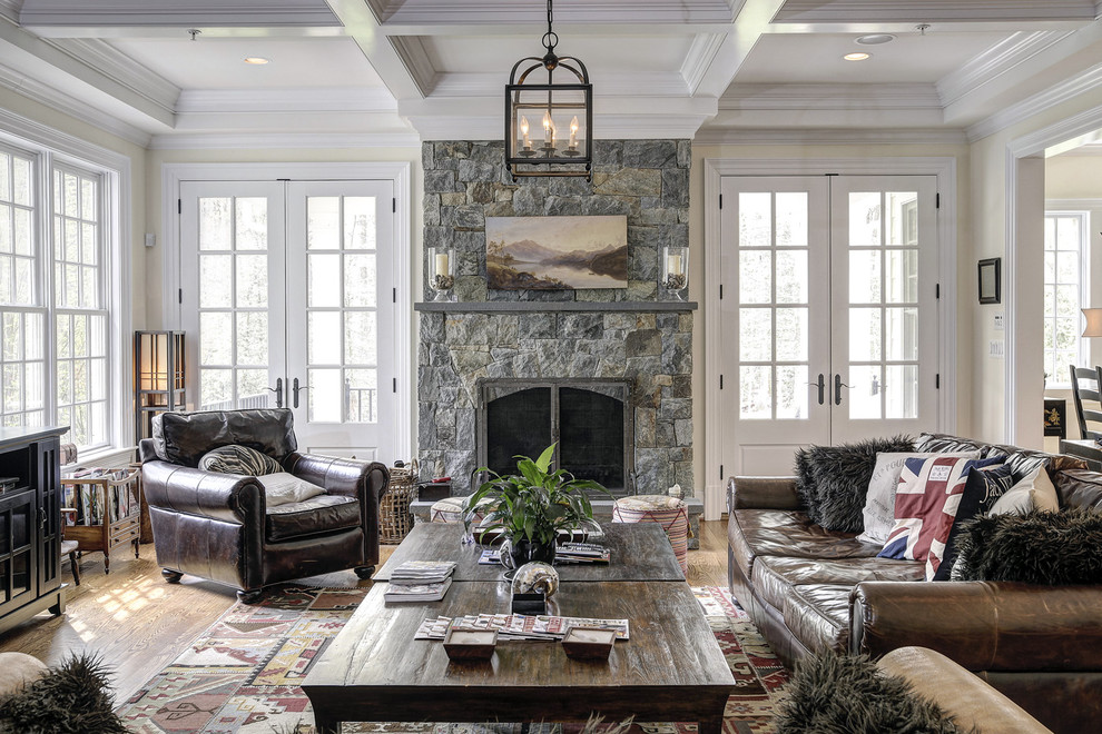 Inspiration for a traditional family room in DC Metro with beige walls, medium hardwood floors, a standard fireplace and a stone fireplace surround.