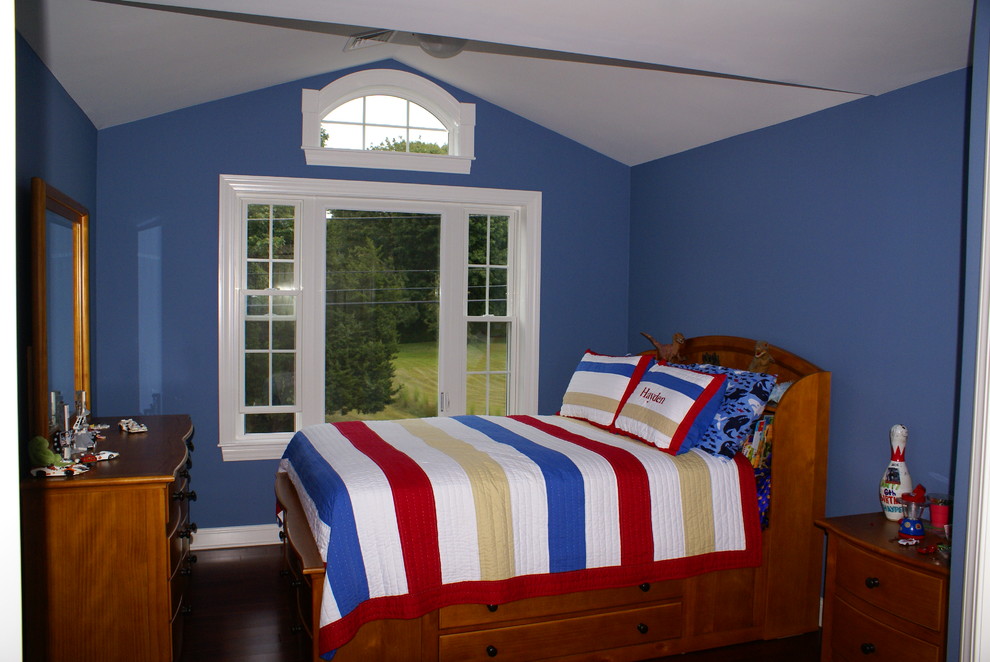This is an example of a mid-sized arts and crafts bedroom in Providence with blue walls and dark hardwood floors.