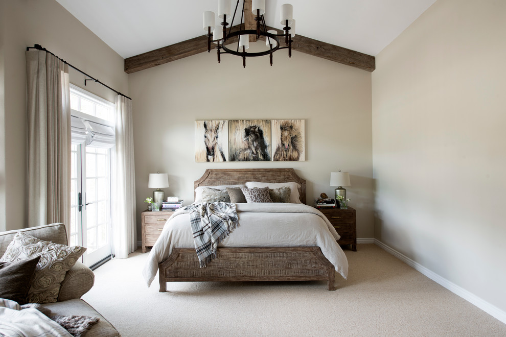 Photo of a mid-sized country master bedroom in Los Angeles with beige walls, carpet and a stone fireplace surround.
