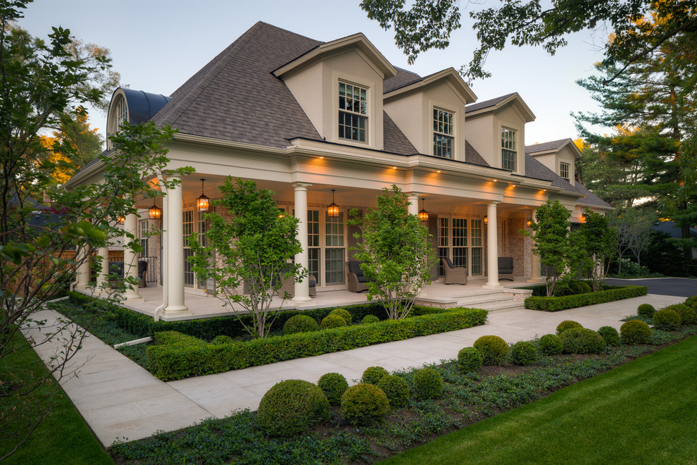Inspiration for a timeless beige two-story exterior home remodel in Toronto with a hip roof