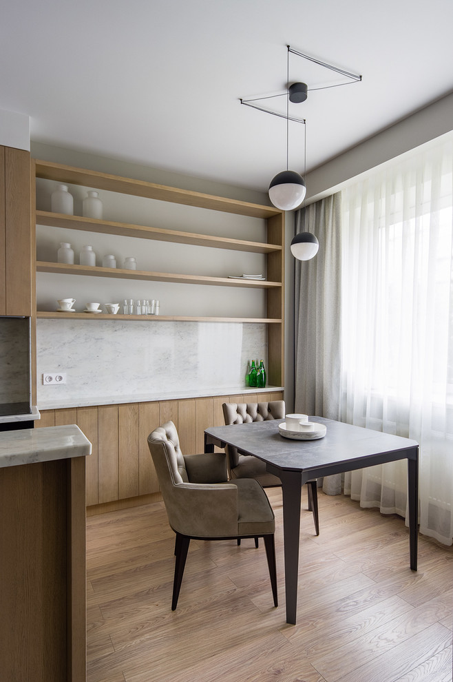Inspiration for a mid-sized contemporary u-shaped open plan kitchen in Moscow with flat-panel cabinets, light wood cabinets, marble benchtops, grey splashback, stone slab splashback and light hardwood floors.