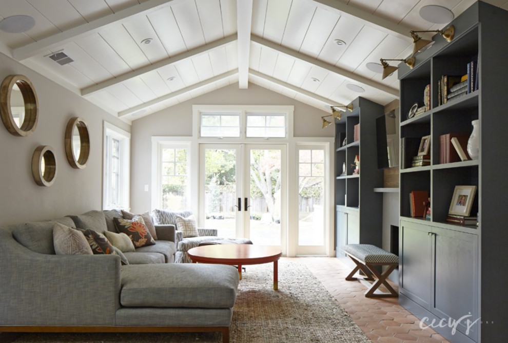 Design ideas for a small country open concept family room in San Francisco with grey walls, terra-cotta floors, a standard fireplace, a tile fireplace surround and a wall-mounted tv.