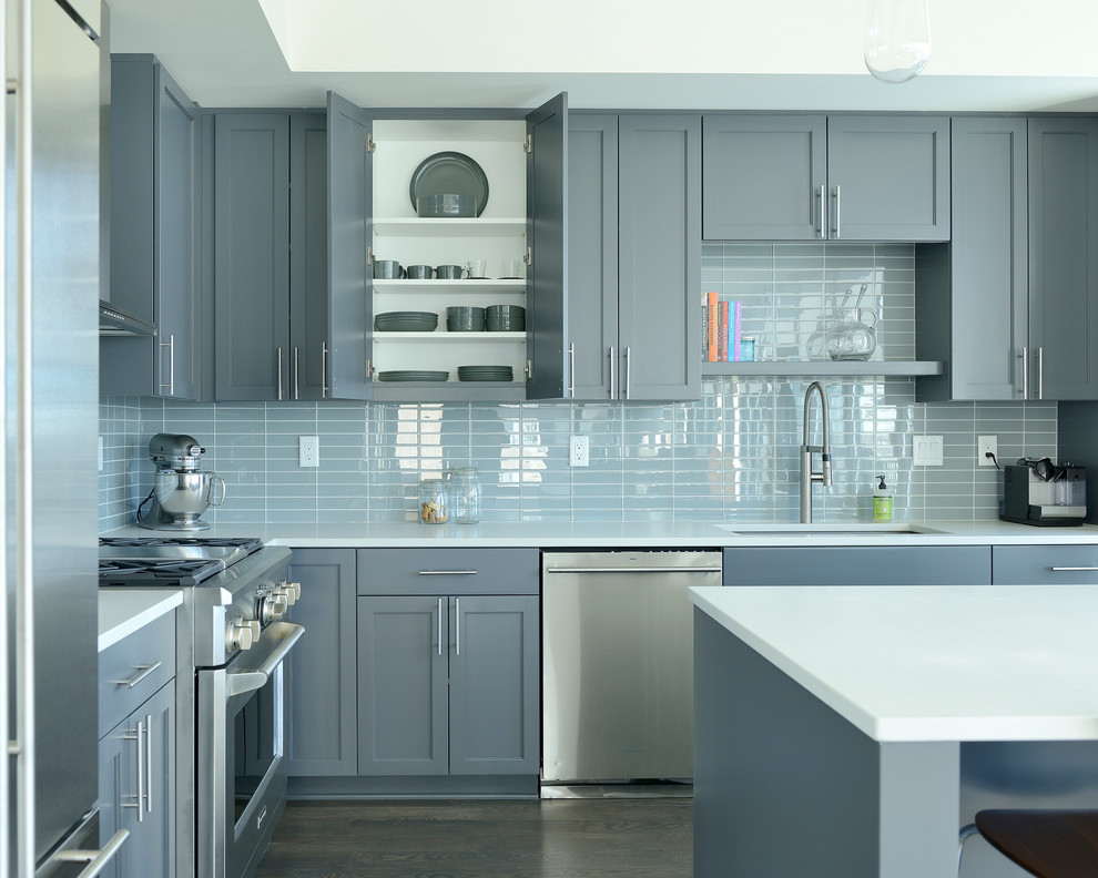Kitchen - transitional l-shaped dark wood floor and brown floor kitchen idea in Minneapolis with an undermount sink, shaker cabinets, gray cabinets, gray backsplash, stainless steel appliances, an island and white countertops