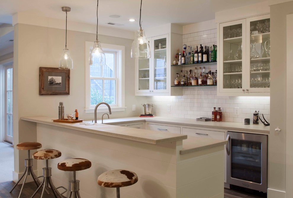 Design ideas for a country u-shaped seated home bar in San Francisco with glass-front cabinets, white cabinets, white splashback and subway tile splashback.