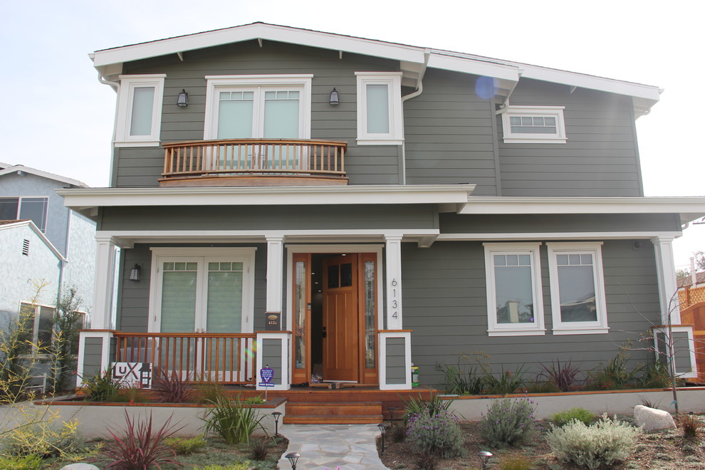 Photo of a mid-sized traditional two-storey grey exterior in Los Angeles with wood siding.
