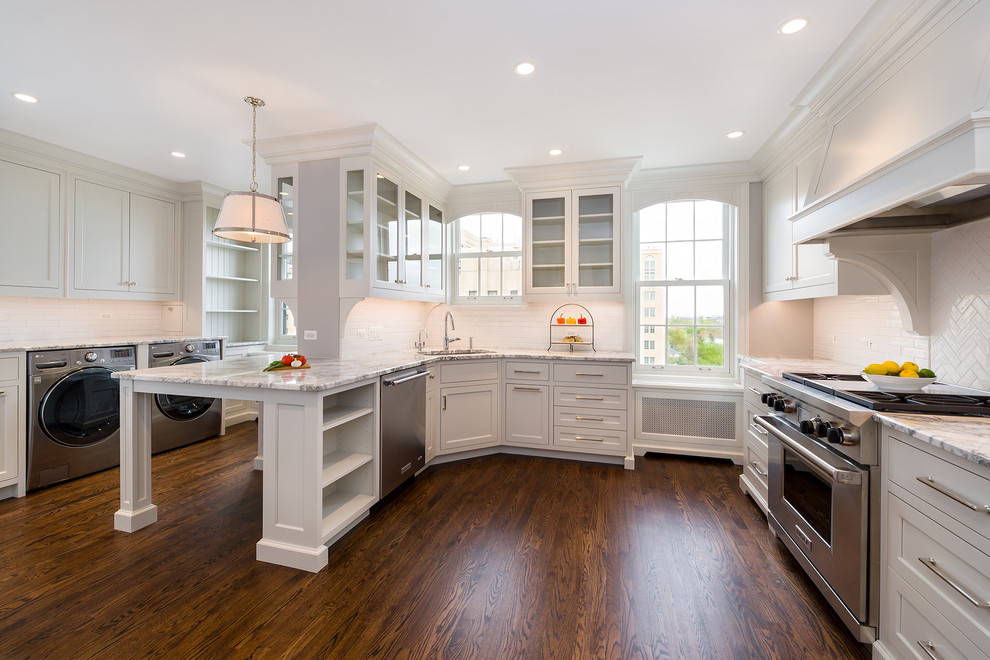 Eat-in kitchen - mid-sized transitional u-shaped dark wood floor and brown floor eat-in kitchen idea in Chicago with beaded inset cabinets, white cabinets, marble countertops, white backsplash, subway tile backsplash, stainless steel appliances and a peninsula