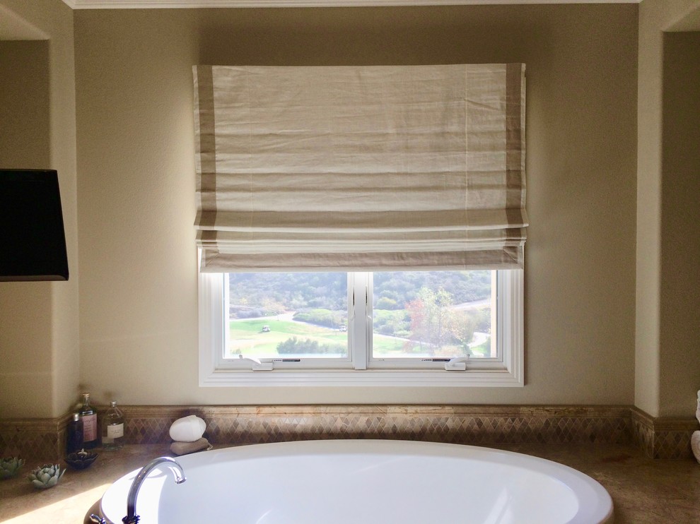 Inspiration for a mid-sized transitional drop-in bathtub remodel in Orange County with beige walls