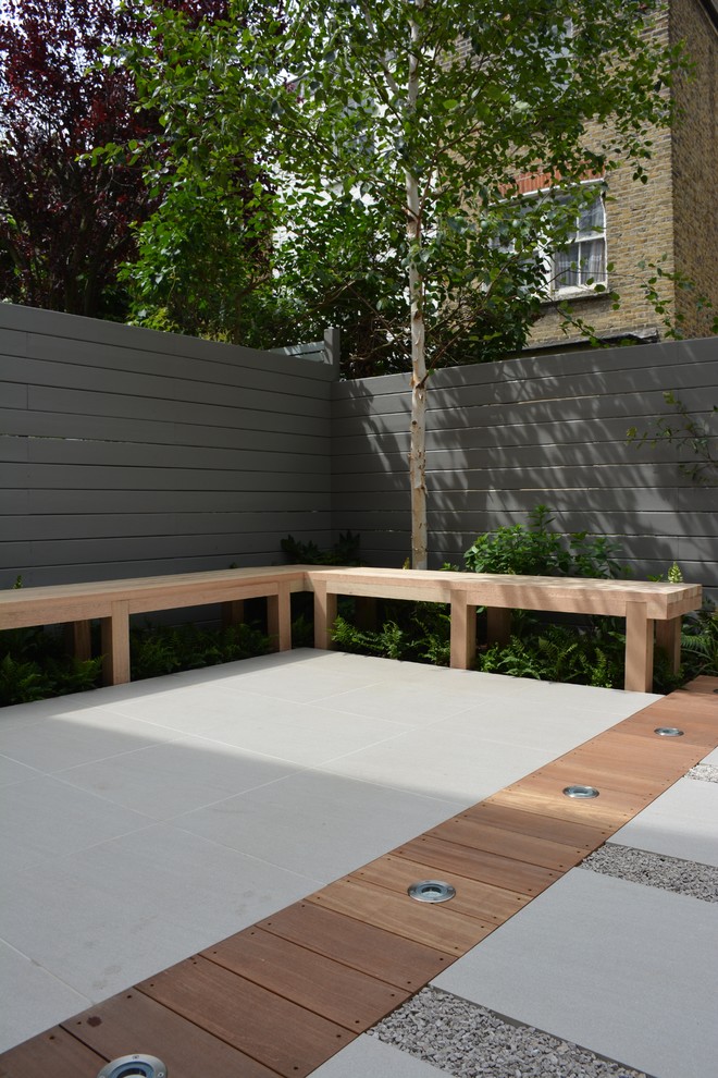 Small contemporary back partial sun garden for summer in London.