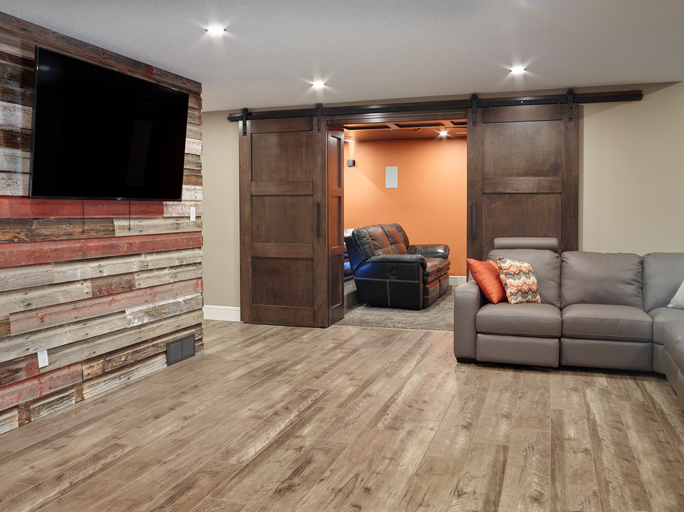 Design ideas for a mid-sized country walk-out basement in Vancouver with multi-coloured walls and light hardwood floors.