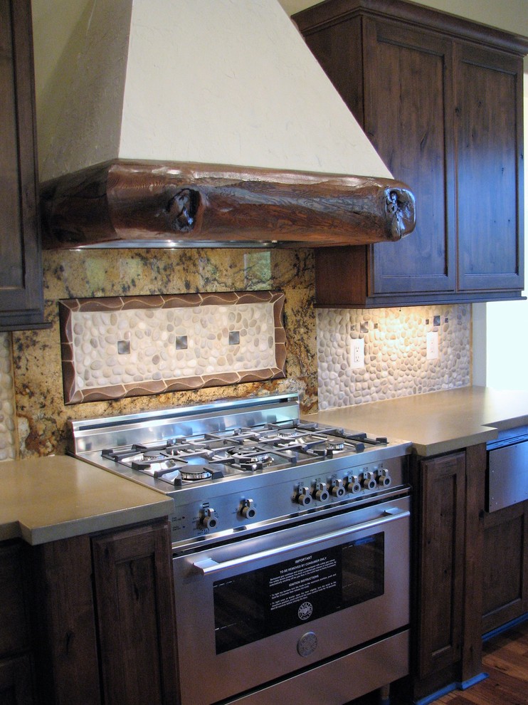 Open concept kitchen - large rustic u-shaped medium tone wood floor and brown floor open concept kitchen idea in Seattle with beaded inset cabinets, distressed cabinets, granite countertops, beige backsplash, stone tile backsplash, stainless steel appliances and an island