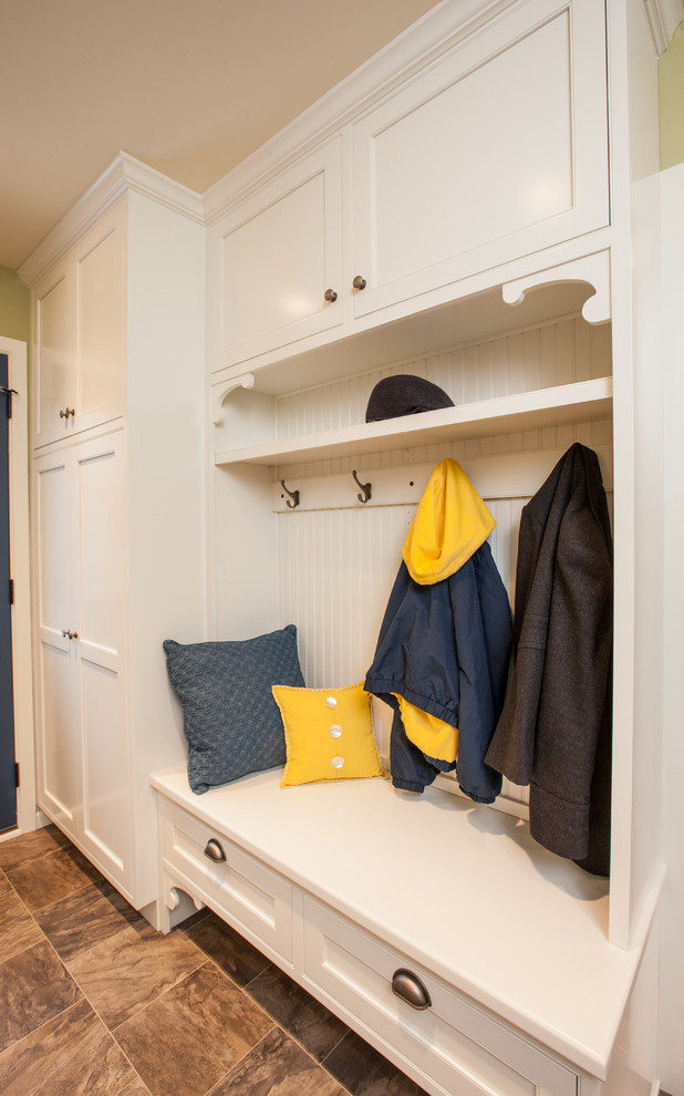 Design ideas for a mid-sized traditional mudroom in Minneapolis with green walls and vinyl floors.