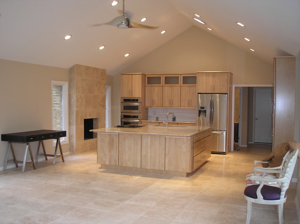 Trendy marble floor kitchen photo with an undermount sink, flat-panel cabinets, light wood cabinets, marble countertops, beige backsplash and stainless steel appliances