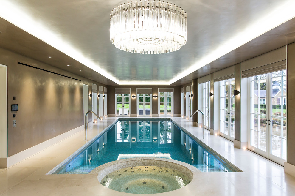 Inspiration for a large transitional indoor rectangular lap pool in Essex with a hot tub.