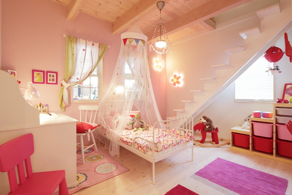 Scandinavian kids' room in Other with multi-coloured walls and light hardwood floors for girls.