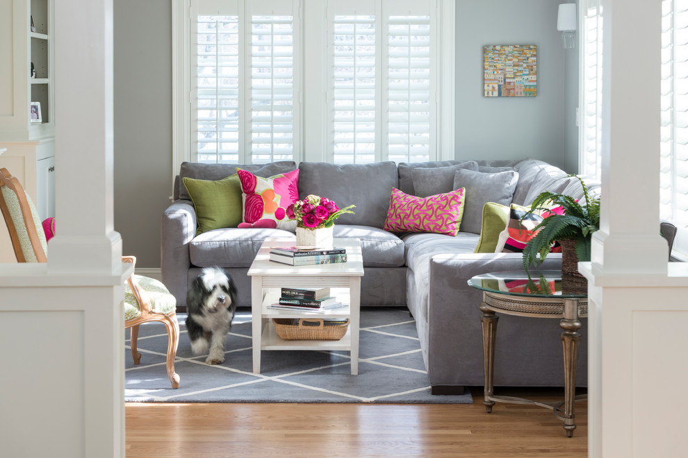 Inspiration for a mid-sized timeless enclosed medium tone wood floor family room remodel in Boston with gray walls
