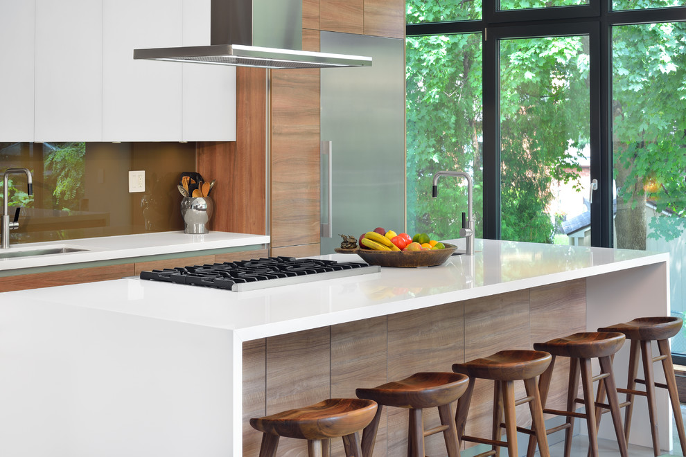 Inspiration for a contemporary kitchen in Toronto with a single-bowl sink, flat-panel cabinets, medium wood cabinets, quartzite benchtops, brown splashback, stone slab splashback, stainless steel appliances and with island.