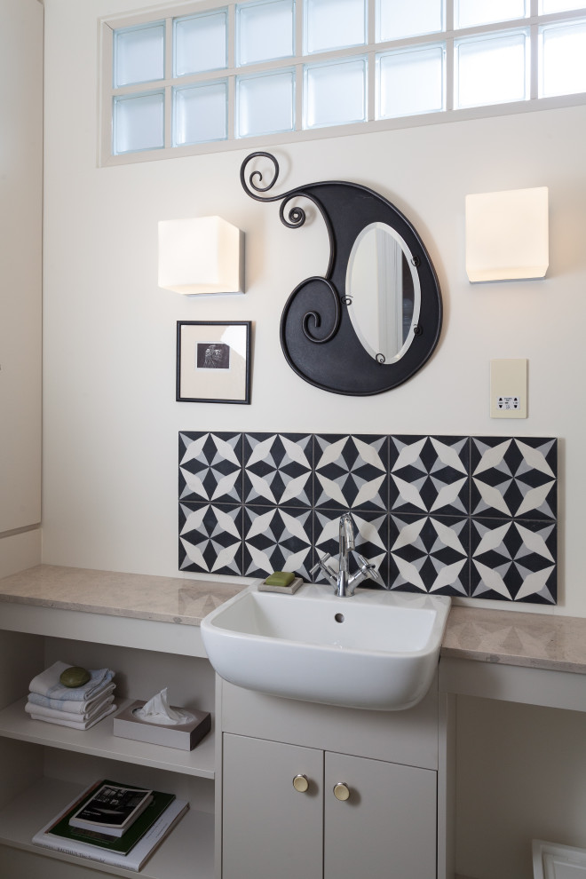 Photo of a small contemporary master bathroom with flat-panel cabinets, beige cabinets, a one-piece toilet, black and white tile, ceramic tile, white walls, a drop-in sink, soapstone benchtops, beige benchtops, a single vanity and a built-in vanity.
