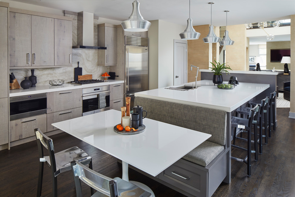 This is an example of a contemporary galley eat-in kitchen in Chicago with flat-panel cabinets, light wood cabinets, beige splashback, stainless steel appliances, dark hardwood floors, with island and brown floor.