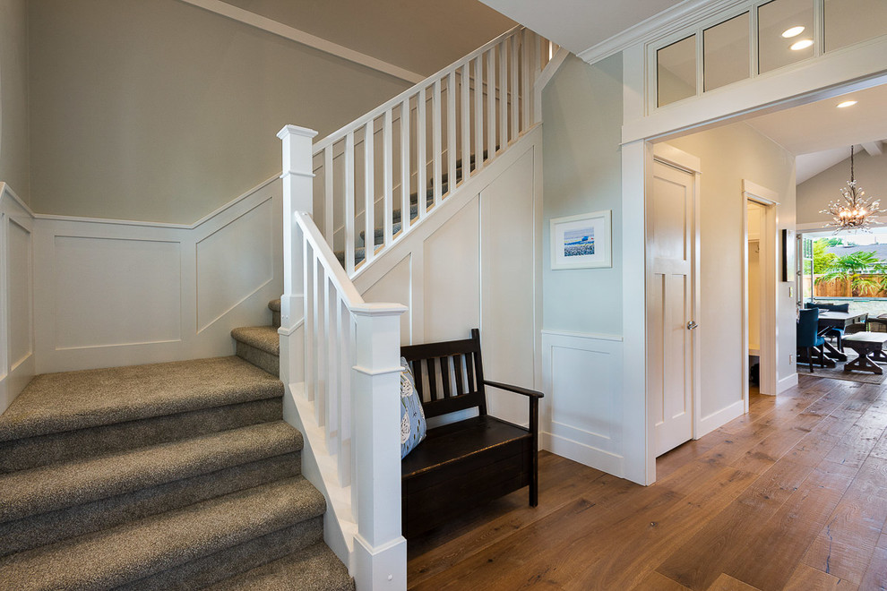 Example of a mid-sized transitional medium tone wood floor and brown floor foyer design with gray walls