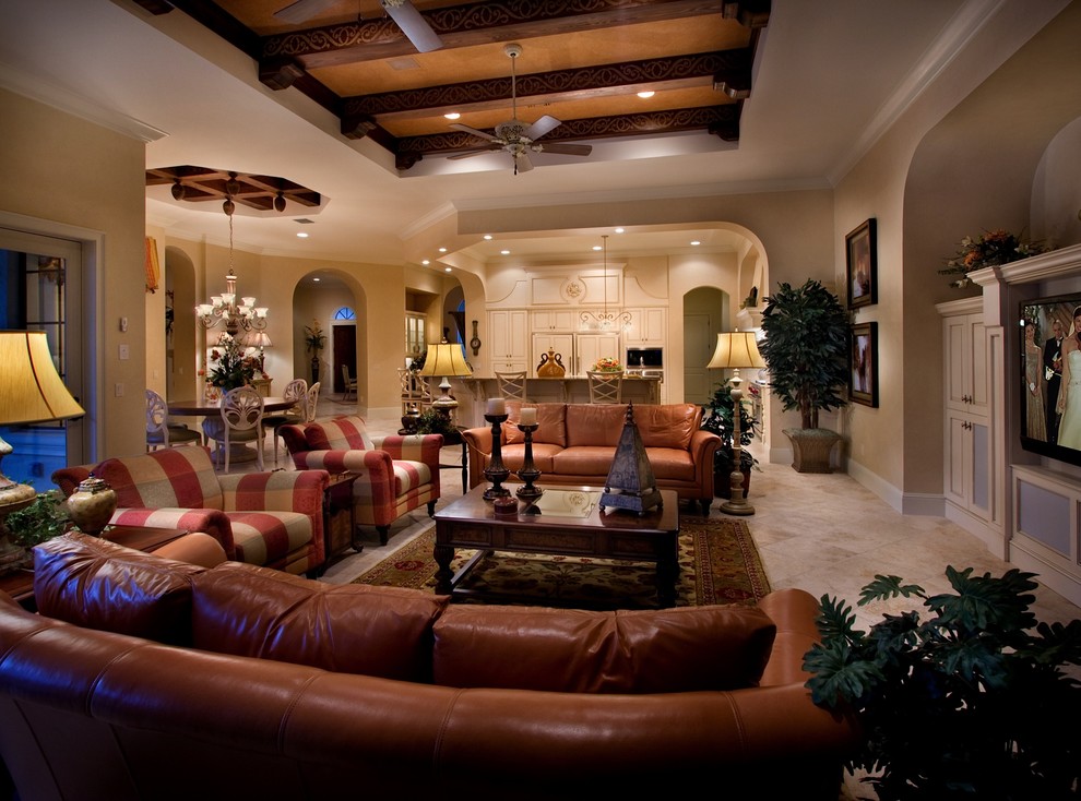 Photo of a large mediterranean open concept living room in Orlando with beige walls, travertine floors and a wall-mounted tv.