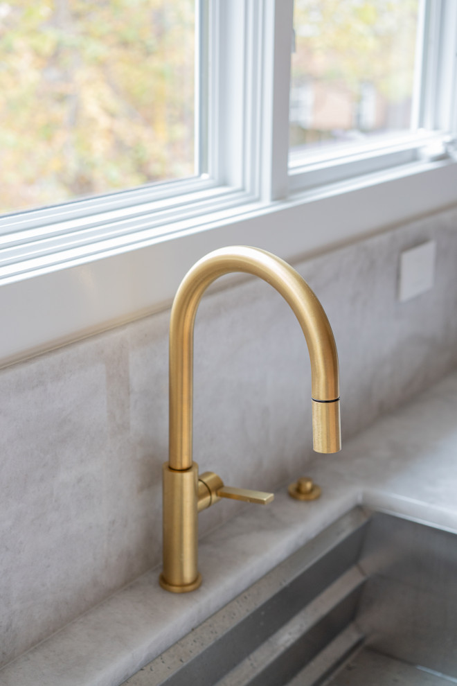 Elegant Gold Kitchen Faucet in Modern Design by a Large Window