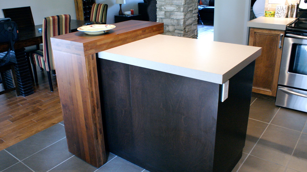 Example of a small transitional eat-in kitchen design with a drop-in sink, shaker cabinets, brown cabinets, laminate countertops, multicolored backsplash, stone slab backsplash, stainless steel appliances and an island