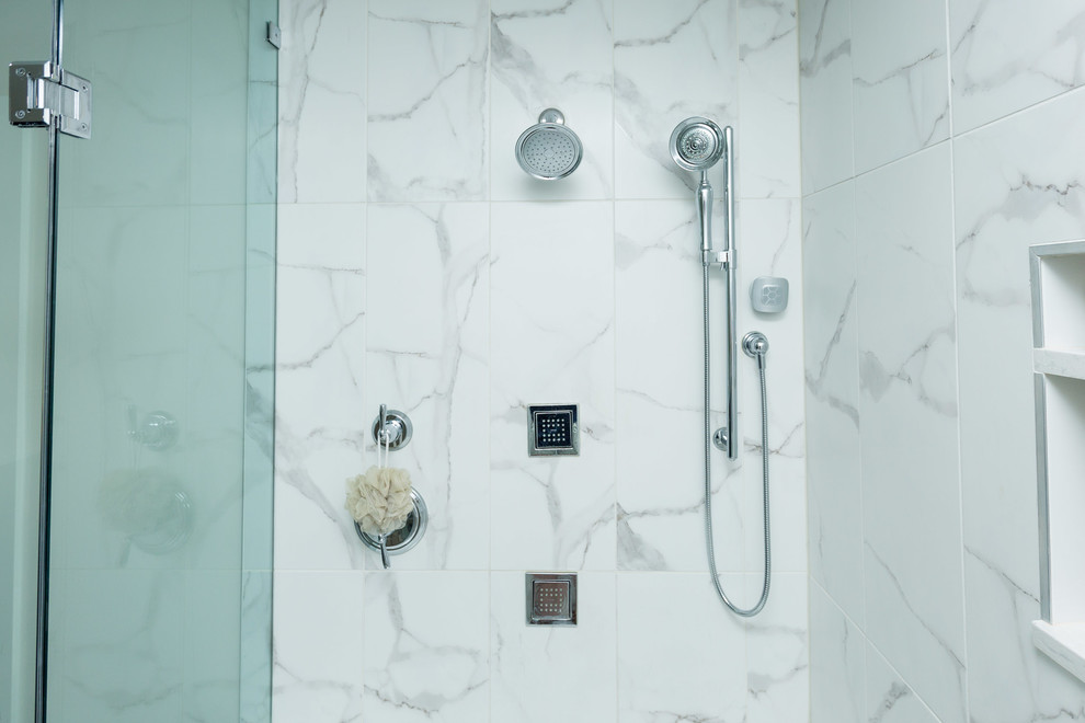 Inspiration for a large transitional master bathroom in DC Metro with shaker cabinets, blue cabinets, an alcove tub, a corner shower, a two-piece toilet, white tile, marble, beige walls, plywood floors, an undermount sink, marble benchtops, brown floor, a hinged shower door and white benchtops.
