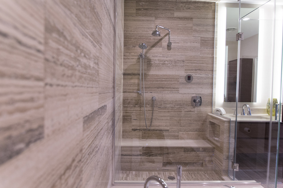 This is an example of a large contemporary bathroom in New York with an undermount sink, flat-panel cabinets, dark wood cabinets, quartzite benchtops, a drop-in tub, beige tile, stone tile, beige walls, travertine floors and with a sauna.