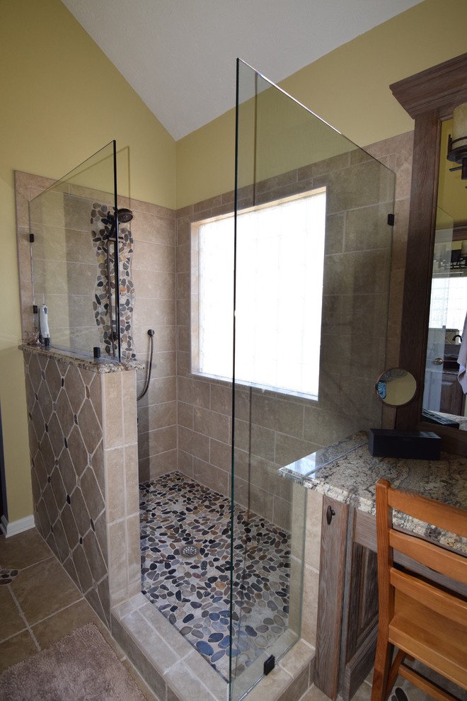This is an example of a small arts and crafts master bathroom in Atlanta with a vessel sink, furniture-like cabinets, medium wood cabinets, granite benchtops, a corner shower, beige tile, ceramic tile, yellow walls and ceramic floors.
