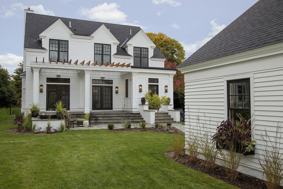 Design ideas for a traditional two-storey white exterior in Minneapolis.