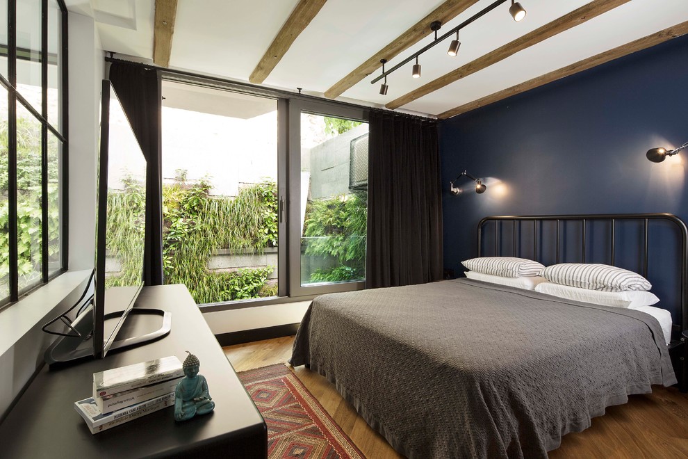 This is an example of a contemporary bedroom in Other with multi-coloured walls.