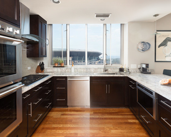 Open concept kitchen - mid-sized transitional u-shaped medium tone wood floor open concept kitchen idea in Chicago with an undermount sink, shaker cabinets, dark wood cabinets, marble countertops, white backsplash, subway tile backsplash, stainless steel appliances and a peninsula