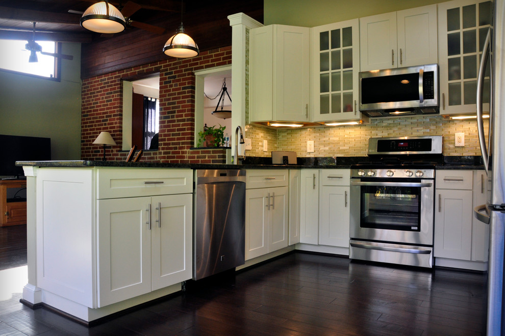 Mid-sized transitional u-shaped dark wood floor eat-in kitchen photo in DC Metro with an undermount sink, white cabinets, granite countertops, yellow backsplash, glass tile backsplash, stainless steel appliances, a peninsula and shaker cabinets