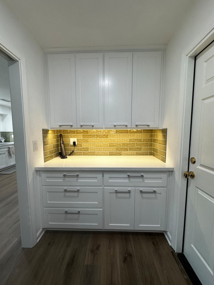 Inspiration for a mid-sized transitional galley laundry room in Other with a single-bowl sink, shaker cabinets, white cabinets, quartz benchtops, green splashback, subway tile splashback and white benchtop.