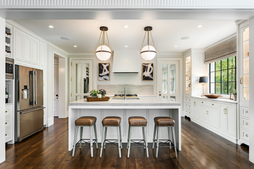 Example of a large transitional u-shaped medium tone wood floor and brown floor eat-in kitchen design with an undermount sink, recessed-panel cabinets, white cabinets, gray backsplash, stainless steel appliances, an island, gray countertops, marble countertops and stone slab backsplash