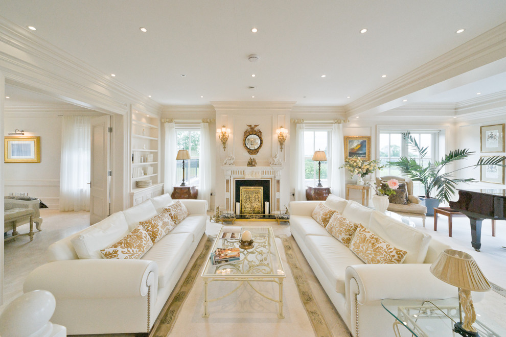 Inspiration for a large traditional formal open concept living room in Dublin with beige walls, limestone floors, a standard fireplace, a stone fireplace surround, no tv and beige floor.