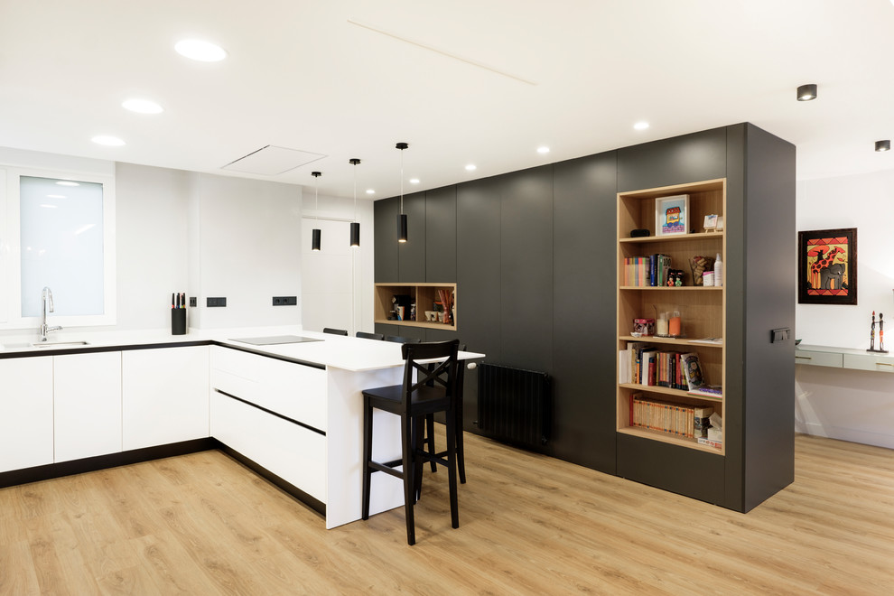 Inspiration for a large contemporary u-shaped kitchen in Other with flat-panel cabinets, white cabinets, quartz benchtops, white splashback, panelled appliances, laminate floors, a peninsula and white benchtop.